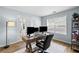 This home office includes a large window, a sleek desk, and French doors at 2360 Brookgreen Commons, Kennesaw, GA 30144
