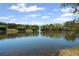 Beautiful lake view with fountain, trees, and blue skies, showcasing community amenities at 2360 Brookgreen Commons, Kennesaw, GA 30144