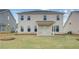 View of the back of a two-story home with a covered patio and a large, well-maintained lawn at 537 Teversham Dr, Mcdonough, GA 30253