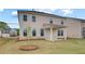 A view of the back of a two-story home with a covered patio and a sprawling green lawn at 537 Teversham Dr, Mcdonough, GA 30253