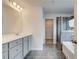 Stylish bathroom featuring dual sinks, a large mirror, and a shower and tub combination at 537 Teversham Dr, Mcdonough, GA 30253