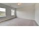 Bright bedroom with carpet, neutral walls, and two windows offering natural light at 537 Teversham Dr, Mcdonough, GA 30253