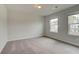 Bright bedroom with carpet, neutral walls, and natural light from two windows at 537 Teversham Dr, Mcdonough, GA 30253