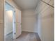Walk-in closet with open shelving and convenient access to the bathroom at 537 Teversham Dr, Mcdonough, GA 30253