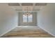 Bright dining room featuring modern chandelier, coffered ceilings and wood-look flooring at 537 Teversham Dr, Mcdonough, GA 30253