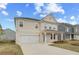 Inviting two-story home with a two-car garage and nicely landscaped front yard at 537 Teversham Dr, Mcdonough, GA 30253