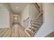 Spacious foyer featuring wood-look floors and an elegant staircase with wooden handrail at 537 Teversham Dr, Mcdonough, GA 30253