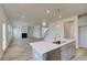 Open concept kitchen with stainless steel appliances, modern gray cabinetry, and views to the living area at 537 Teversham Dr, Mcdonough, GA 30253