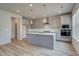 Open kitchen featuring gray cabinets, stainless appliances, and a central island with pendant lighting at 537 Teversham Dr, Mcdonough, GA 30253