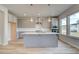 Bright kitchen with gray cabinetry, stainless steel appliances, large island, and plenty of natural light at 537 Teversham Dr, Mcdonough, GA 30253