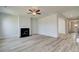 Cozy living room features a modern fireplace, neutral paint, and wood-look flooring at 537 Teversham Dr, Mcdonough, GA 30253