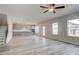 Spacious open layout with wood flooring seamlessly flowing from living area to the kitchen with grey cabinets at 537 Teversham Dr, Mcdonough, GA 30253