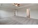 Spacious main bedroom featuring a ceiling fan, carpet, and two entryways at 537 Teversham Dr, Mcdonough, GA 30253