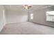 Spacious main bedroom with trey ceiling, carpet, and natural light from two windows at 537 Teversham Dr, Mcdonough, GA 30253