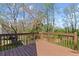 A spacious wooden back deck overlooks a lush, green backyard surrounded by mature trees at 5635 Charleston Bay Dr, Cumming, GA 30041