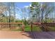 A spacious wooden back deck overlooks a lush, green backyard surrounded by mature trees at 5635 Charleston Bay Dr, Cumming, GA 30041