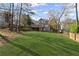 A large, grassy backyard has a wooden deck and steps leading from the home at 5635 Charleston Bay Dr, Cumming, GA 30041
