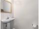 Powder room with pedestal sink and framed mirror at 5635 Charleston Bay Dr, Cumming, GA 30041