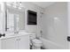 Well-lit bathroom with a single vanity, bathtub, shower, and modern fixtures at 5635 Charleston Bay Dr, Cumming, GA 30041