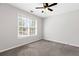 Bright bedroom with large window, neutral walls, and carpet flooring at 5635 Charleston Bay Dr, Cumming, GA 30041