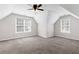 Large bedroom with two windows, neutral walls, and carpet flooring at 5635 Charleston Bay Dr, Cumming, GA 30041