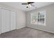 Inviting bedroom with a ceiling fan, closet, and carpet flooring at 5635 Charleston Bay Dr, Cumming, GA 30041