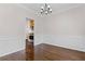 Dining room with hardwood floors, decorative trim, and view into the kitchen at 5635 Charleston Bay Dr, Cumming, GA 30041
