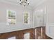 Bright dining room with hardwood floors, white trim, and a modern chandelier at 5635 Charleston Bay Dr, Cumming, GA 30041