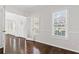 Dining room with hardwood floors, white wainscoting, and large windows at 5635 Charleston Bay Dr, Cumming, GA 30041