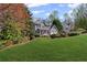 Charming two-story home nestled on a lush green lawn, showcasing a welcoming porch and two-car garage at 5635 Charleston Bay Dr, Cumming, GA 30041