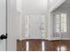 Bright foyer with hardwood floors, a white front door with sidelights and a transom window at 5635 Charleston Bay Dr, Cumming, GA 30041
