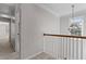 Bright hallway with a chandelier, white trim, and views of the outdoors from the window at 5635 Charleston Bay Dr, Cumming, GA 30041