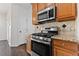 Modern kitchen featuring stainless steel appliances, granite countertops, and stylish tile backsplash at 5635 Charleston Bay Dr, Cumming, GA 30041