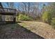 Large backyard with foliage and an upper deck showing home's exterior at 180 Sable Cir, Covington, GA 30016
