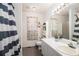 Bright bathroom with a striped shower curtain and a modern vanity with a large mirror at 180 Sable Cir, Covington, GA 30016