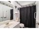 Bathroom featuring a single sink, toilet, mirror and shower with a black curtain at 180 Sable Cir, Covington, GA 30016