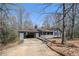 Charming ranch home features an open carport, a front porch and a spacious yard at 180 Sable Cir, Covington, GA 30016