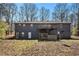 Exterior back of home with a large upper deck and partial walk-out basement at 180 Sable Cir, Covington, GA 30016