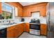 The kitchen features wood cabinets, white countertops, and stainless steel appliances at 180 Sable Cir, Covington, GA 30016