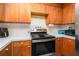 Cozy kitchen featuring wood cabinets, white countertops and stainless steel appliances at 180 Sable Cir, Covington, GA 30016