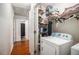 A well-lit laundry room with appliances and shelving at 180 Sable Cir, Covington, GA 30016