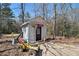 Outdoor shed features basketball hoop and a small parking area for a small off-road vehicle at 180 Sable Cir, Covington, GA 30016