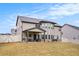 Backyard shot of the house with a covered patio and well-maintained lawn at 224 Osier Dr, Mcdonough, GA 30252