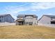 Backyard of a two-story home featuring a large lawn and covered patio area at 224 Osier Dr, Mcdonough, GA 30252