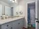 Well-lit bathroom with granite countertop, modern fixtures and a doorway to a tiled shower at 224 Osier Dr, Mcdonough, GA 30252