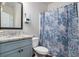 Neat bathroom featuring stone countertop, blue shower curtain and tiled floor at 224 Osier Dr, Mcdonough, GA 30252