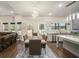 Bright dining room with modern light fixture, table for six and view into the kitchen at 224 Osier Dr, Mcdonough, GA 30252