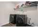 Modern laundry room showcasing a front-load washer and dryer set at 224 Osier Dr, Mcdonough, GA 30252
