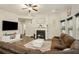 Comfortable living room with a fireplace, a large sectional sofa, and bright windows at 224 Osier Dr, Mcdonough, GA 30252