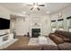 Inviting living room with a fireplace, large TV, and stylish decor at 224 Osier Dr, Mcdonough, GA 30252
